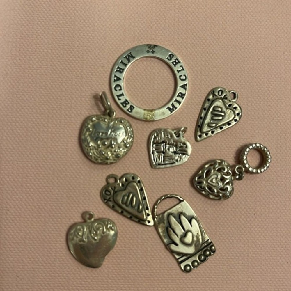 8 Sterling charms, great on necklace or bracelet. 7 hearts, one Miracle disc.